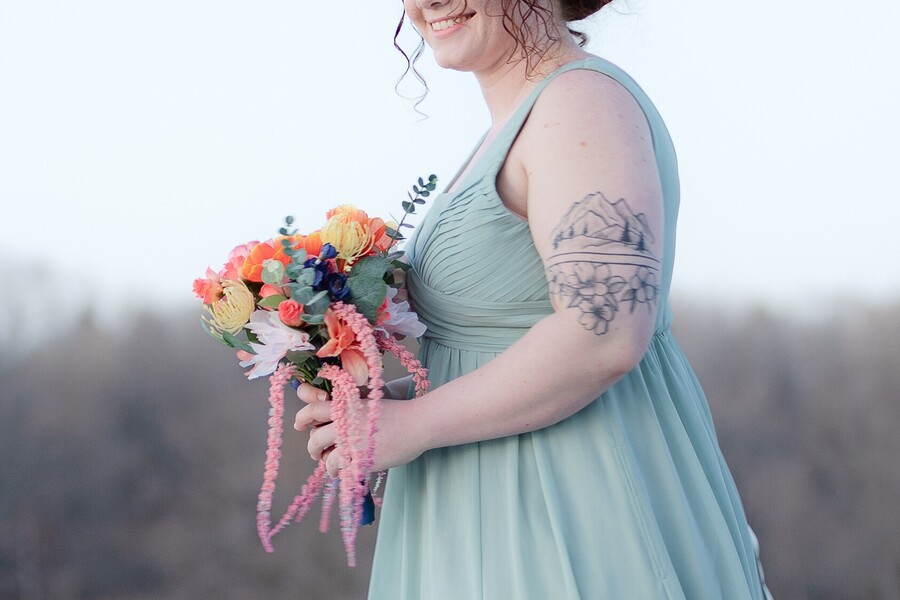 Bridesmaid with flowers taken by an Omaha Wedding Photographer