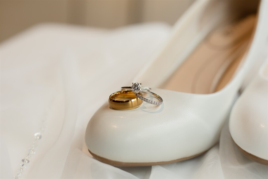 Wedding rings propped up on shoes, taken by an Omaha Wedding Photographer