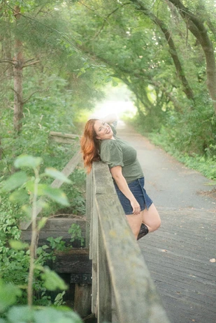 Woman leaning on a bridge in Omaha during portraits