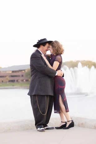 Couple kissing during engagement photos in downtown Omaha, NE